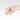 Hand wearing a kite-shaped sterling silver ring with a pink tourmaline centerpiece and textured details.